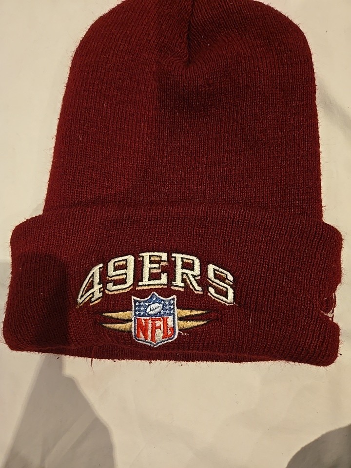 Official San Francisco 49ers knit beanie by NFL Pro Line featuring a burgundy...